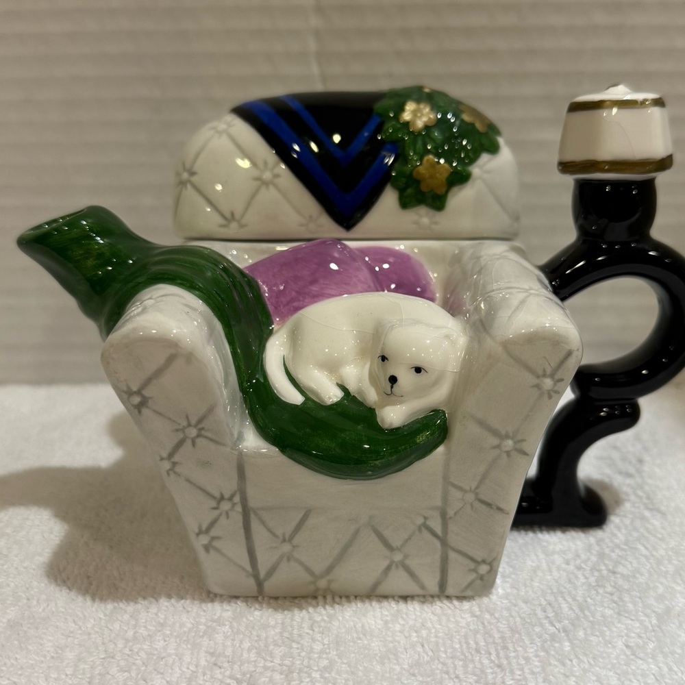 Vintage ceramic chair, teapot with resting white cat